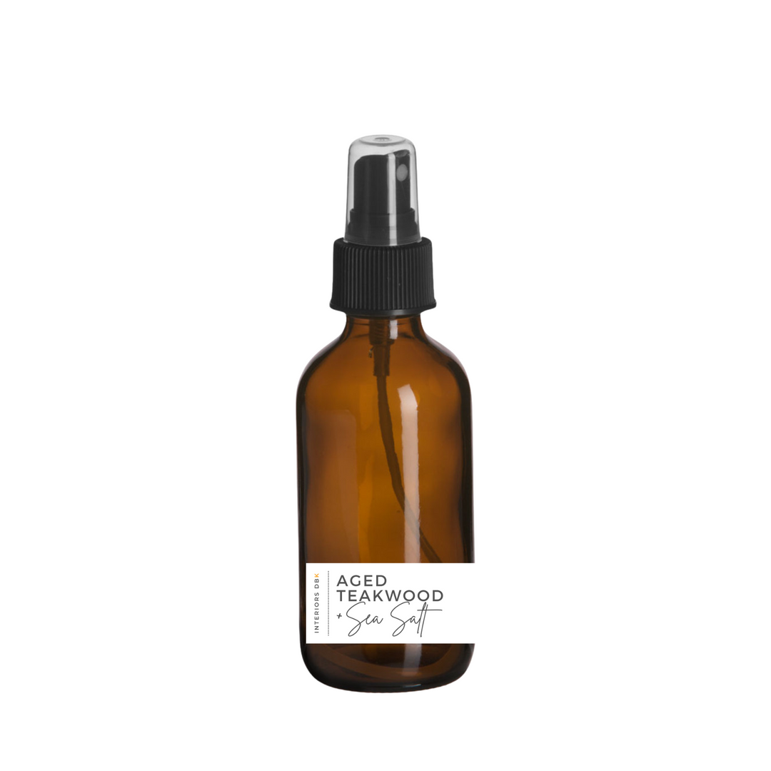 Room spray bottle in amber glass with teakwood and sea salt fragrance.