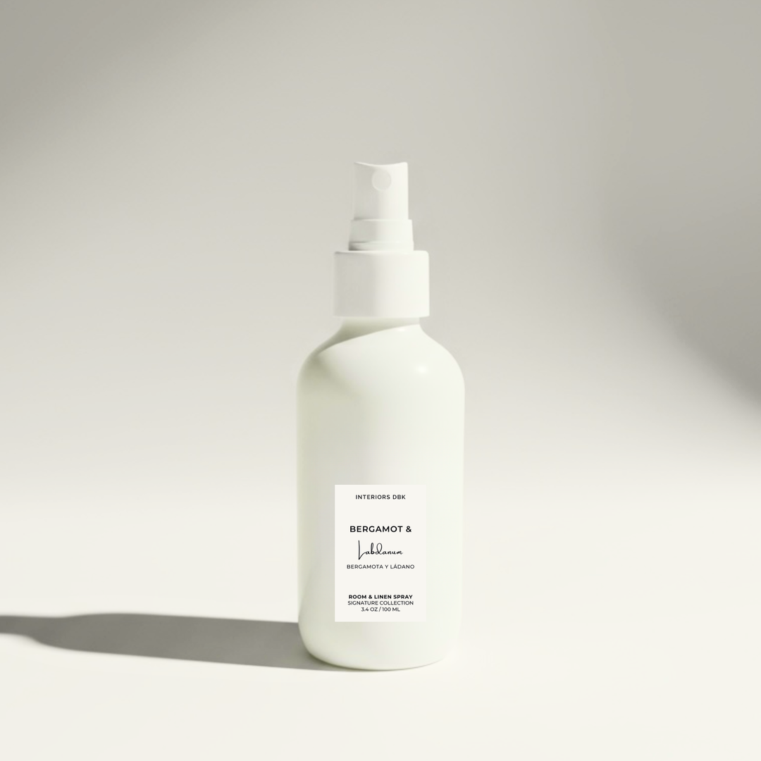 Bergamot & Labdanum room and linen spray by Interiors DBK in white glass bottle, aromatic citrus and resin home fragrance.