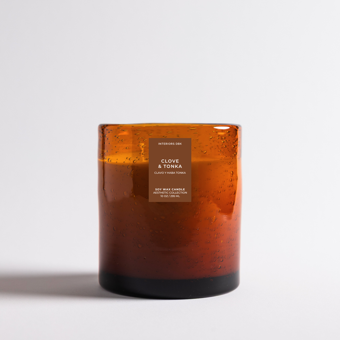 Clove and Tonka soy candle by Interiors DBK. Amber glass candle container.