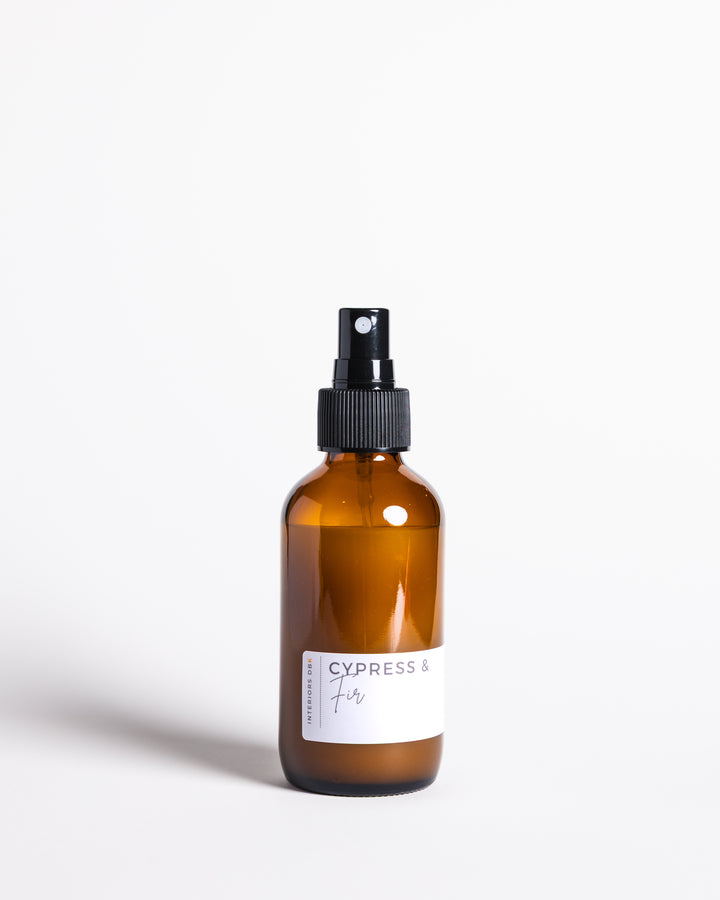 Christmas in a bottle, Cypress & Fir room and linen spray in reusable amber bottle with forest-inspired scent.