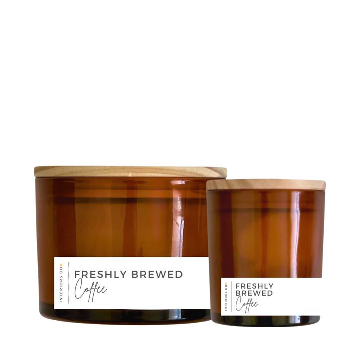 A set of Freshly Brewed Coffee soy candles in amber glass vessels, featuring a small and large candle with natural wood lids, showcasing the cozy and invigorating design.