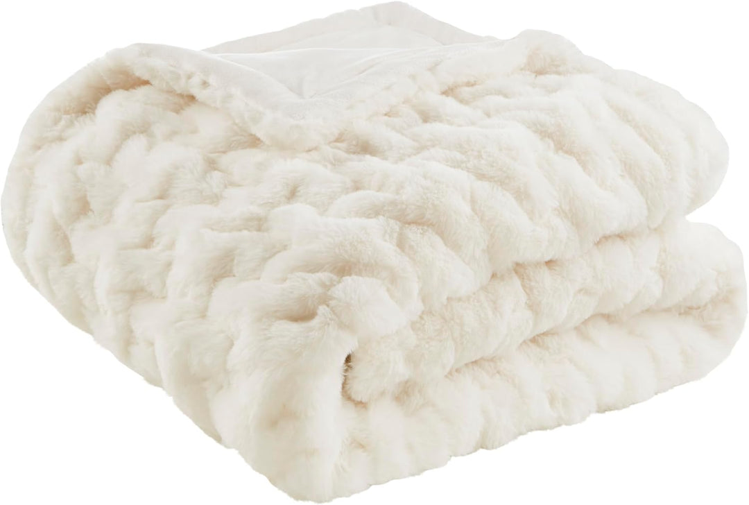 Ivory ruched faux fur throw blanket folded on white background