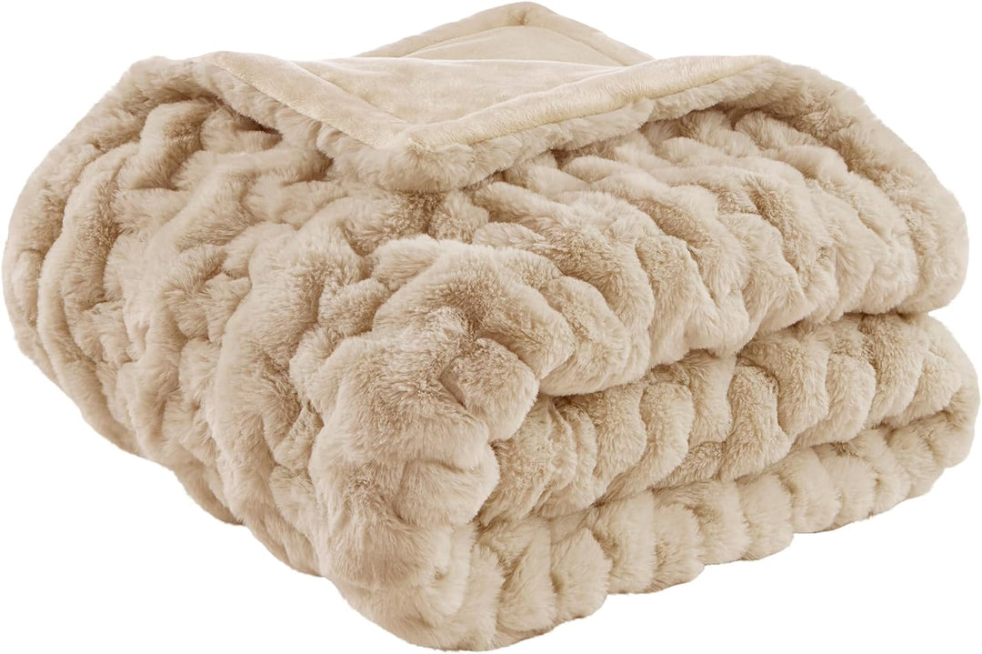 Tan ruched faux fur throw blanket folded on white background