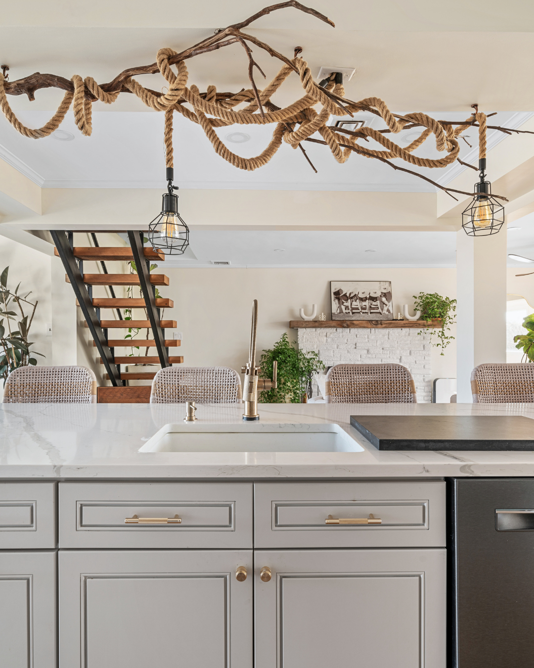 Residential kitchen design by Interiors DBK. Modern kitchen with SW Agreeable Gray cabinets, quartzite countertop, and decorative rope light fixture.