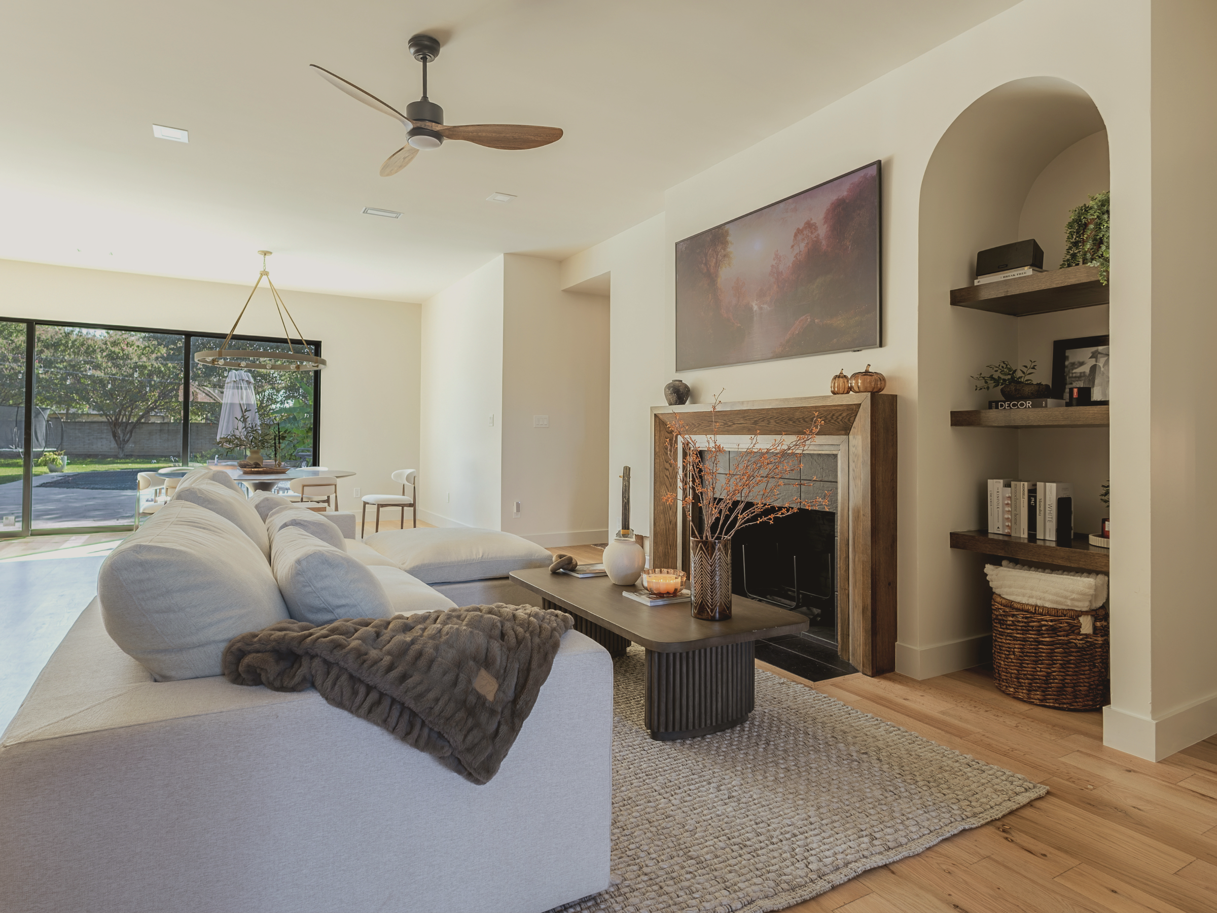 Residential interior design. Living room with a fireplace, television, and decorative items.