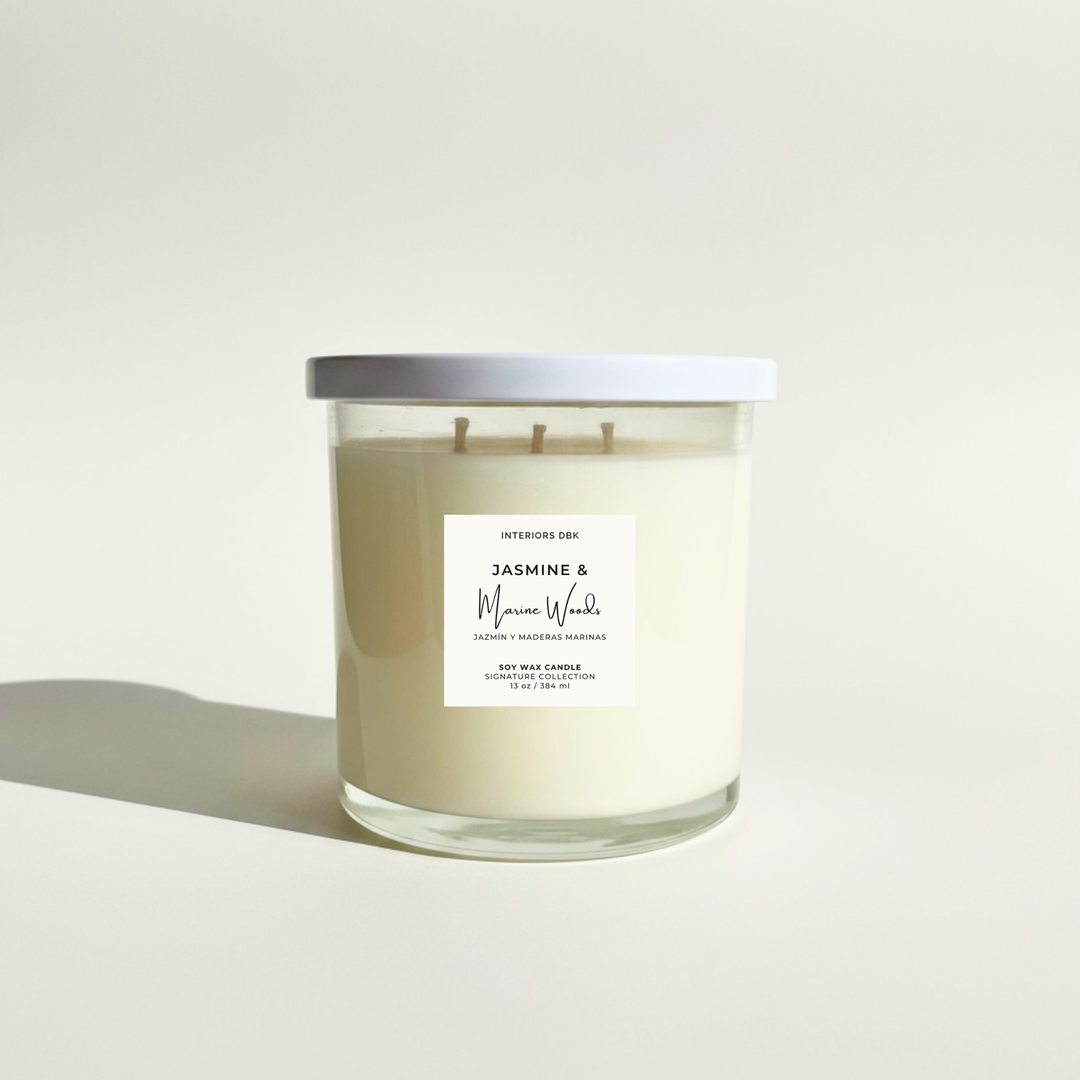 Jasmine & Marine Woods 13 oz soy candle by Interiors DBK with triple wick in clear glass jar.