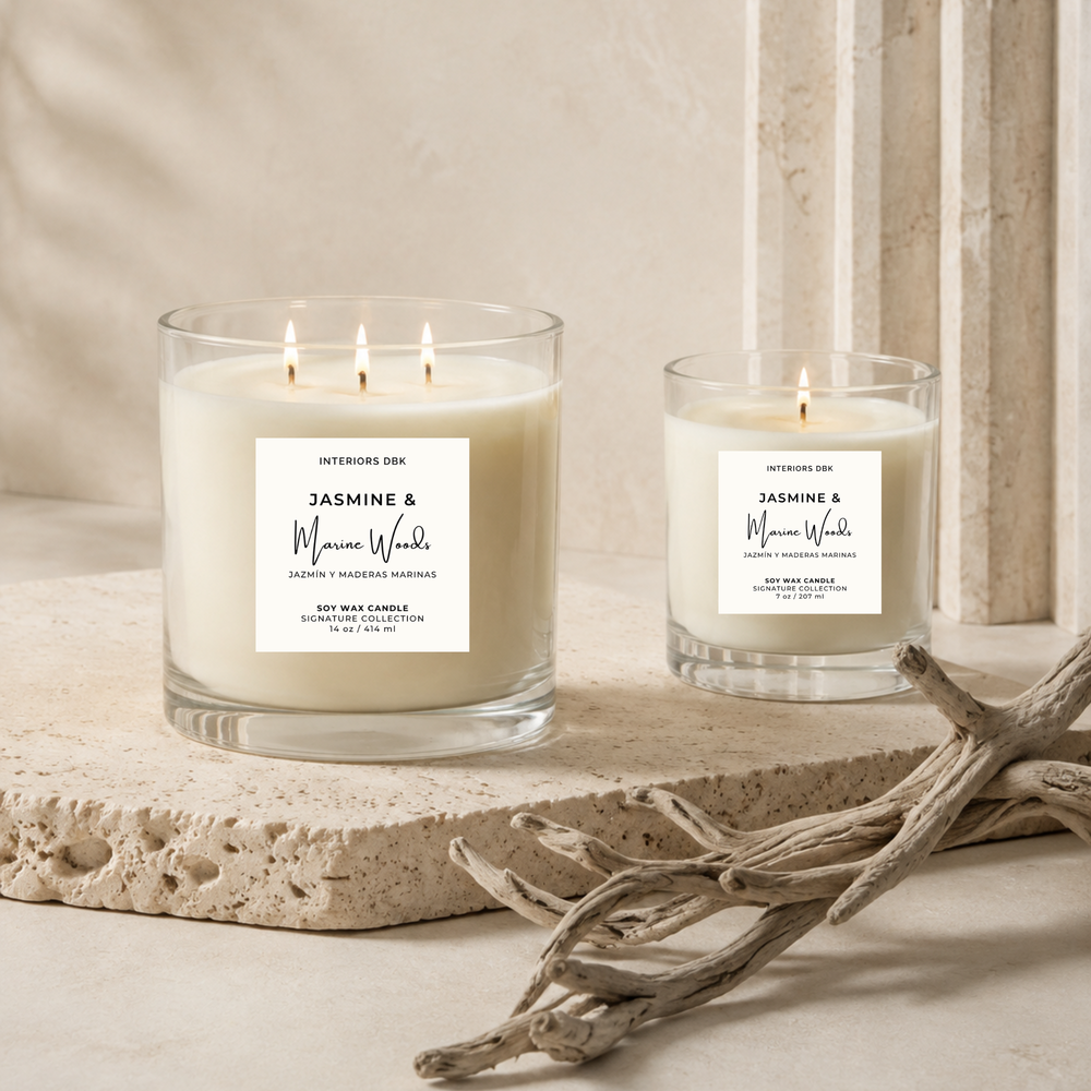 Small and large non-toxic soy candles by Interiors DBK. Jasmine & Marine Woods by Interiors DBK from the Signature Collection. Styled on a stone slab with driftwood in a warm neutral interior setting.