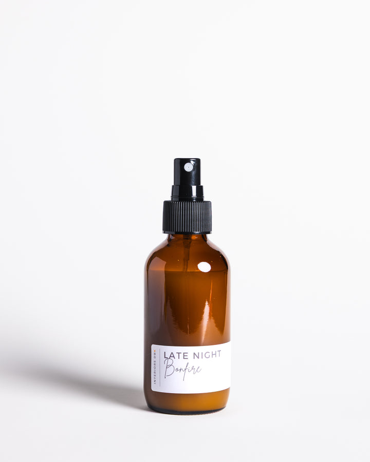 Late Night Bonfire room and linen spray in amber glass bottle.