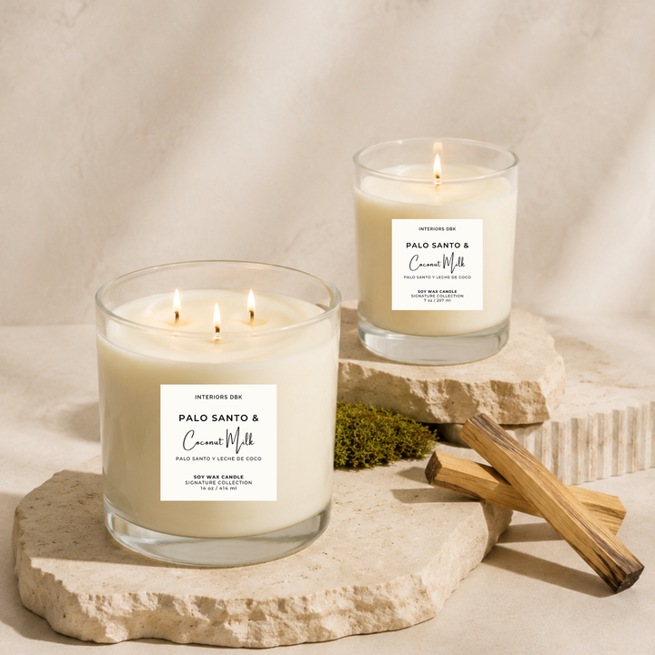 A small and large set of two Palo Santo &amp; Coconut Milk soy wax candles by Interiors DBK in clear glass containers.
