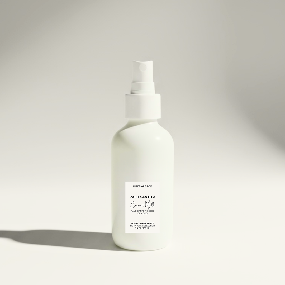 Palo Santo & Coconut Milk room spray by Interiors DBK in white glass bottle, warm woody tropical home fragrance.