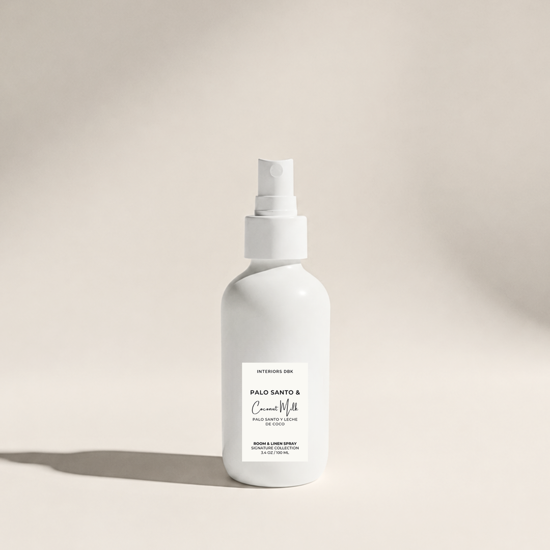 Palo Santo & Coconut Milk room spray by Interiors DBK in white glass bottle, warm woody tropical home fragrance.