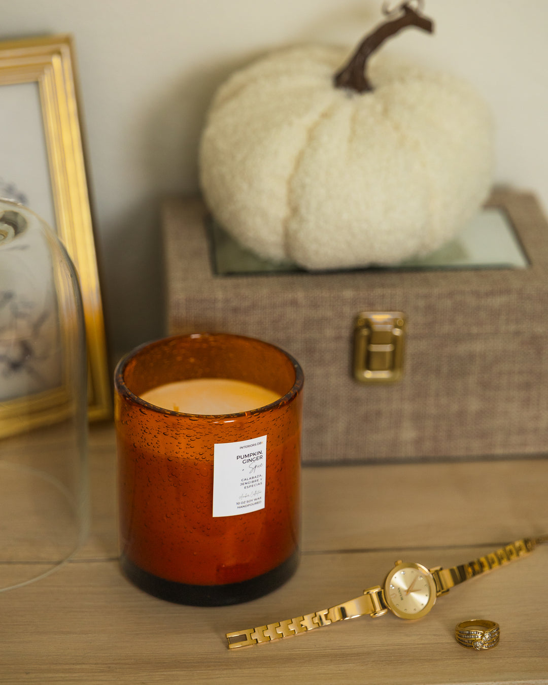 Luxury soy candle with warm pumpkin, spice, and citrus blend in amber glass vessel perfect for the fall season.