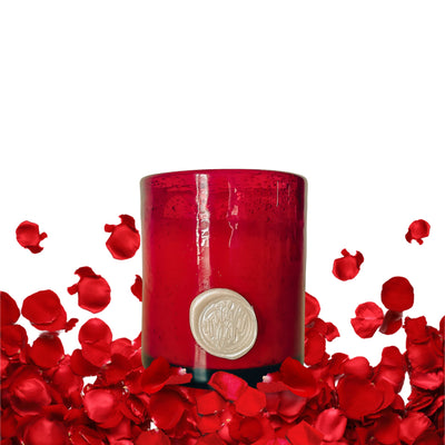 Give the gift of fragrance with our Saffron, Violet, and Sandalwood luxury scented soy candle. Individually poured into a stunning hand-blown red glass container, each candle is a one-of-a-kind piece that can be repurposed once the candle is finished. Share the gift of enduring beauty and let the essence of love linger in the air. Front view.