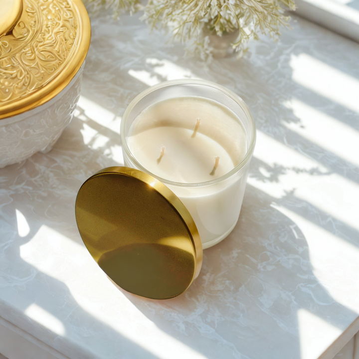Interiors DBK soy wax candle, hand poured with non toxic ingredients in a reusable clear glass container with gold lid. The perfect romantic candle for Valentine's Day.