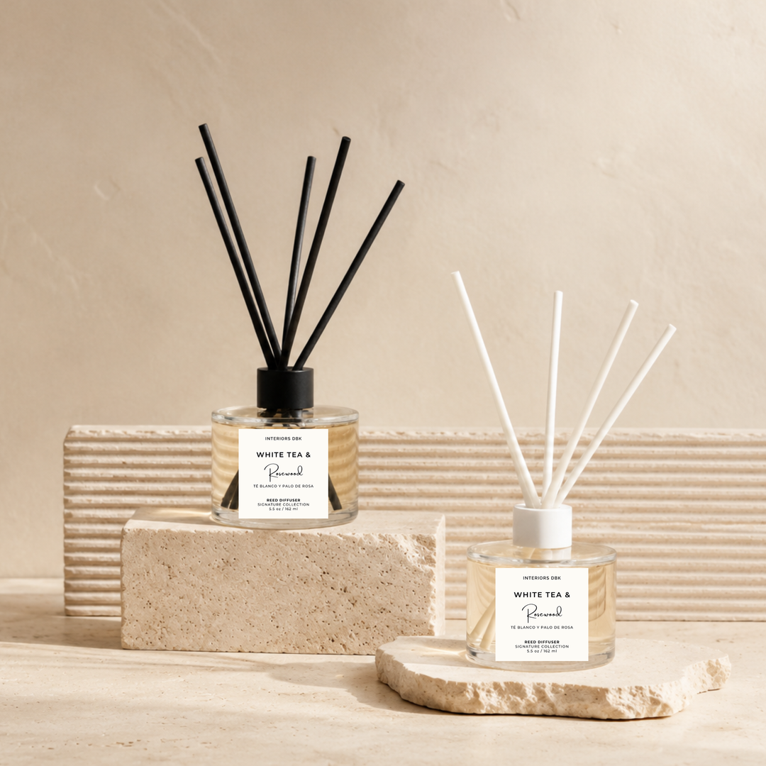 Interiors DBK White Tea &amp; Rosewood reed diffusers in a clear glass vessel with white or black fiber reeds. Non-toxic flameless signature home fragrance.