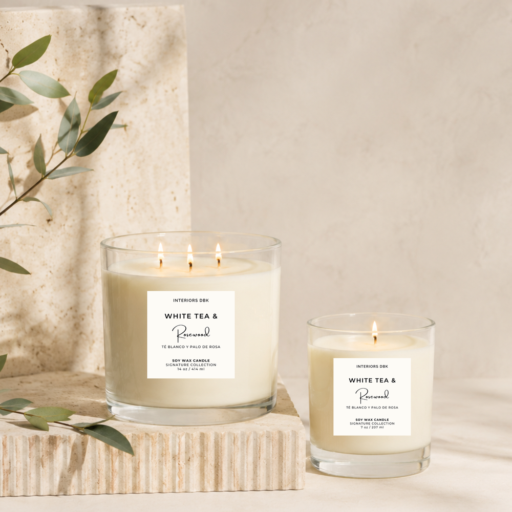 White Tea & Rosewood signature scented soy wax candles by Interiors DBK in a clear glass vessels.