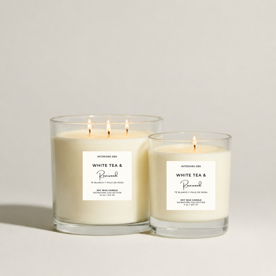 White Tea & Rosewood signature scented soy wax candles by Interiors DBK in a clear glass vessels.