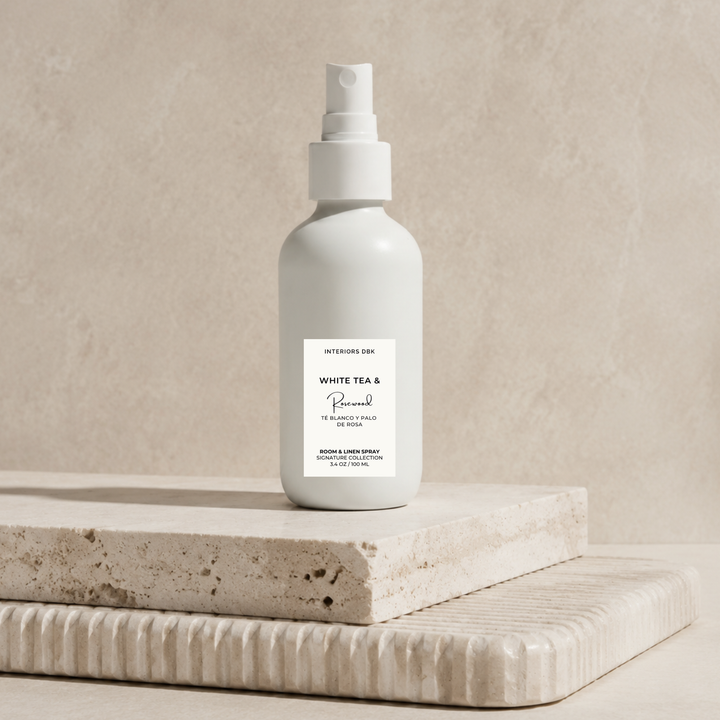 White tea and rosewood signature scent by Interiors DBK. This room and linen spray is poured into a reusable white glass bottle. Non-toxic, clean and flameless home fragrance.