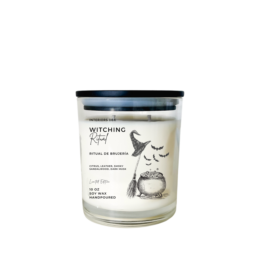 Witching Ritual soy candle in a clear glass vase with a black matte wood lid, featuring a charming label with a bubbling pot, witch’s broom, and bats, designed for Halloween ambiance.